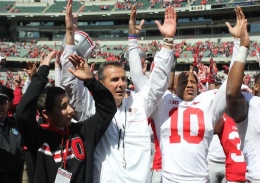 Ohio State football coach Urban Meyer sings Carmen Ohio with his son after the Ohio State Spring Game on April 13. The Scarlet team defeated the Gray, 31-14. 