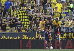 New England Revolution midfielder Chris Tierney takes a corner kick against the Columbus Crew in unfriendly territory in Crew Stadium in Columbus, Ohio, Saturday, July 20, 2013. The Revolution scored two goals in stoppage time to win the match, 2-0.
