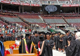 Graduates receive their diplomas during commencement on June 10 at Ohio Stadium.
