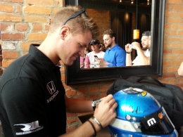 James Jakes signs the helmet that "Jakesy Nation" designed for him, which he gave to the group at a media luncheon on May 21.