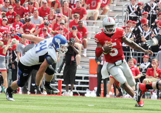 Then-junior quarterback Braxton Miller (5) runs down the field for extra yards in a game against Buffalo Aug. 31 at Ohio Stadium. OSU won, 40-20. Miller will move to a new position for the Buckeyes for the 2015 season. Credit: Lantern file photo
