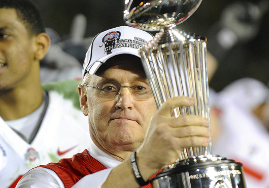 Then-coach Jim Tressel holds the championship trophy after a game against Oregon Jan. 1, 2010, at the Rose Bowl. OSU won, 26-17. Credit: Courtesy of TNS