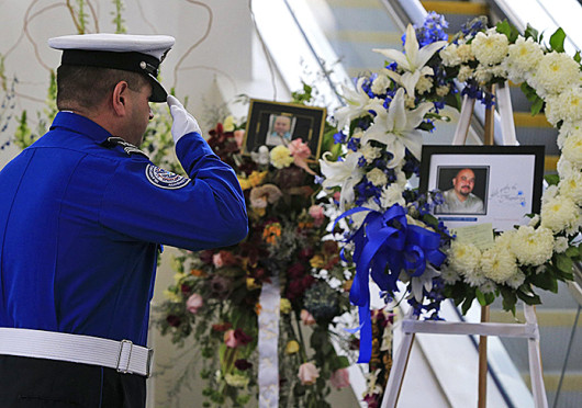A TSA honor guard salutes the picture of slain TSA officer Gerardo Hernandez at Los Angeles International Airport’s Terminal 3 during a moment of silence Nov. 8.