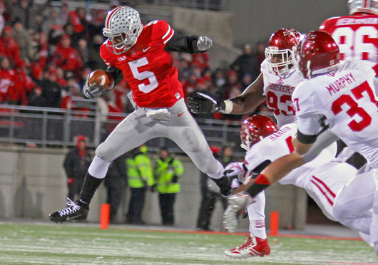 Then-junior quarterback Braxton Miller (5) runs the ball during a game against Indiana Nov. 23 at Ohio Stadium. OSU won, 42-14. On Thursday night, Miller announced that he would be changing positions for the upcoming season. Credit: Lantern file photo