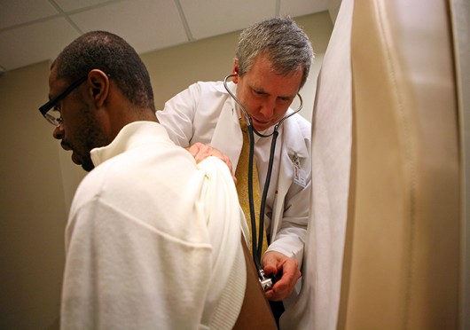 A doctor examines a patient. Some OSU students said they're more likely to stay on their parents insurance because it saves them money. Credit: Courtesy of MCT