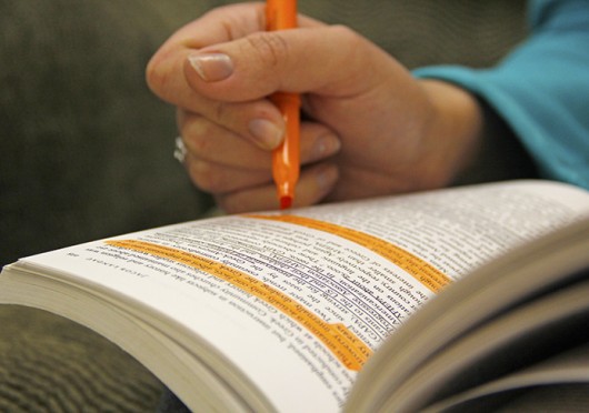 A student highlights a textbook. Some professors recently have encouraged their students to skim read assignments. Credit: Photo illustration by Ritika Shah / Asst. photo editor