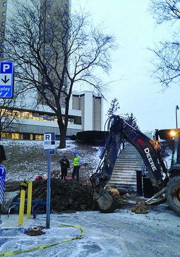 Crew members work to repair a water main break Jan. 22. Water services were shut off in Lincoln and Morrill Towers, the Drake Performance and Event Center and the Women's Field House for more than 5 hours.<br />Credit: Daniel Bendtsen / Senior Lantern reporter