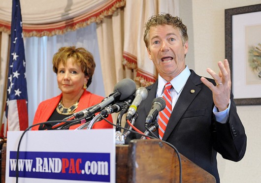 Senator Rand Paul (R-Ky.) speaks at a news conference to announce legal action against government surveillance and the National Security Agency's overreach of power, Thursday, June 13, 2013, at the Capitol Hill Club in Washington, D.C. Woman at left is unidentified. (Olivier Douliery/Abaca Press/MCT)