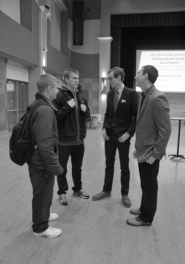 (From left) Nick Brausch, Russell Patterson, Nick Macek and Vytas Aukstuolis talk at a USG campaigning event Feb. 17. Credit: Thy Thy Nguyen / Lantern reporter