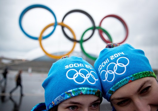 People pose for a picture under the Olympic rings at the Olympic Park in Sochi, Russia, Jan. 31.  Credit: Courtesy of MCT