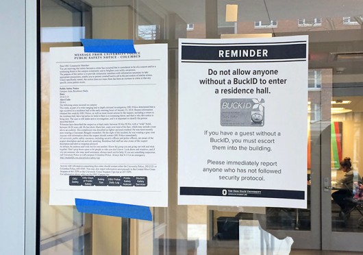 Signs are posted at residence hall entrances advising students to follow building access policies. Credit: Liz Young / Campus editor