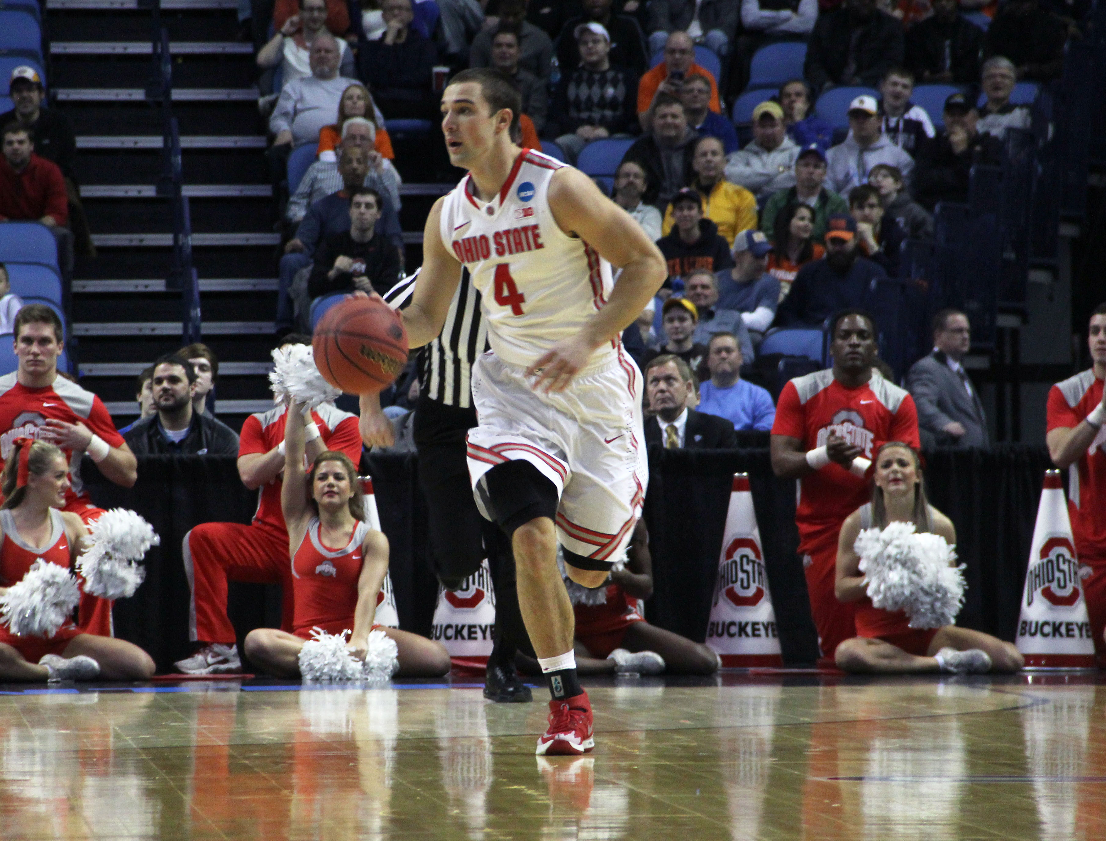 Senior guard Aaron Craft (4) carries the ball down the court in a game against Dayton. OSU lost, 60-59, at First Niagara Center March 20.