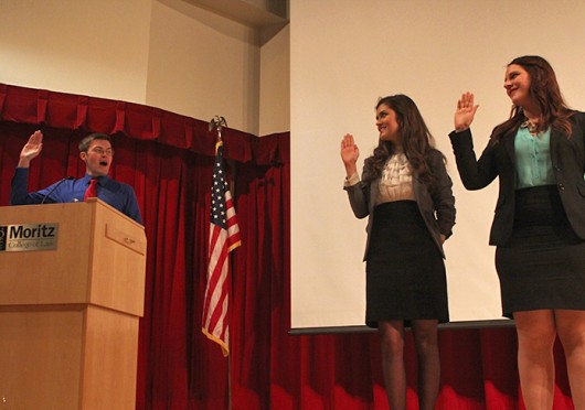 USG President Celia Wright, middle, and Vice President Leah Lacure take their oath of office March 26 at Drinko Hall.<br />Credit: Logan Hickman / Lantern photographer