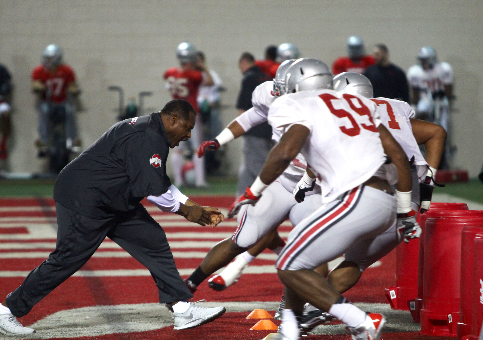 OSU defensive line coach Larry Johnson runs drills with players during spring practice March 20 at the Woody Hayes Athletic Center.