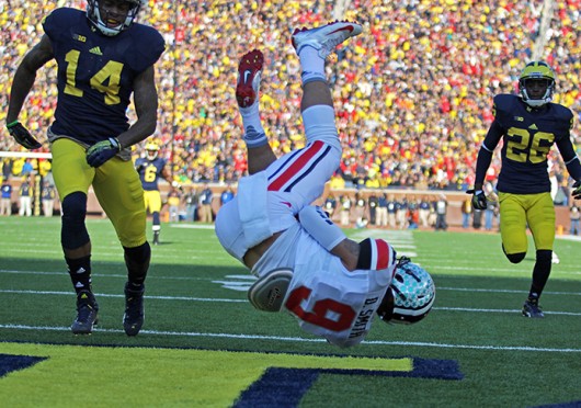 Then-junior wide receiver Devin Smith (9) falls to the ground after catching a touchdown pass during a game against Michigan Nov. 30 at Michigan Stadium. OSU won, 42-41. Lantern file photo
