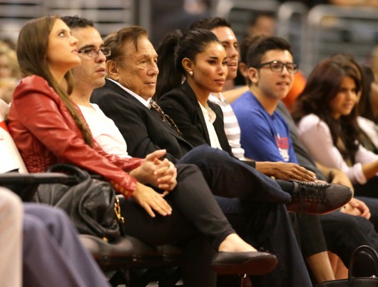 Los Angeles Clippers owner Donald Sterling sits courtside with V. Stiviano during a game against the Utah Jazz at the Staples Center in October 2013.  Credit: Courtesy of MCT
