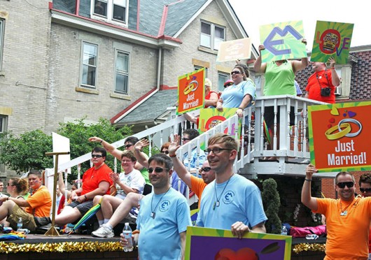 A float carries couples who were recently married June 22 on High Street as part of Pride Parade 2013. Credit: Shelby Lum / Photo editor