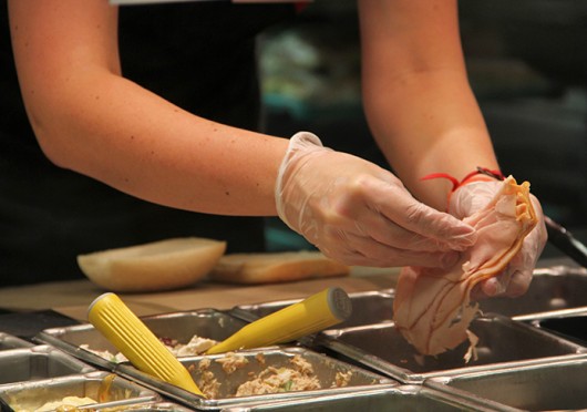 A student-employee prepares a sandwich at a Campus Dining location. OSU employees who make minimum wage could get a raise if legislation to increase the minimum wage passes in Ohio. Credit: Ritika Shah / Asst. photo editor