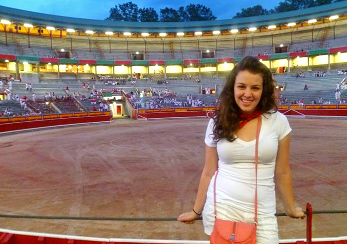 OSU student Michele Theodore stands at a bullfighting ring in Pamplona, Spain, during the annual festival of San Fermin while she studied abroad in 2013.
