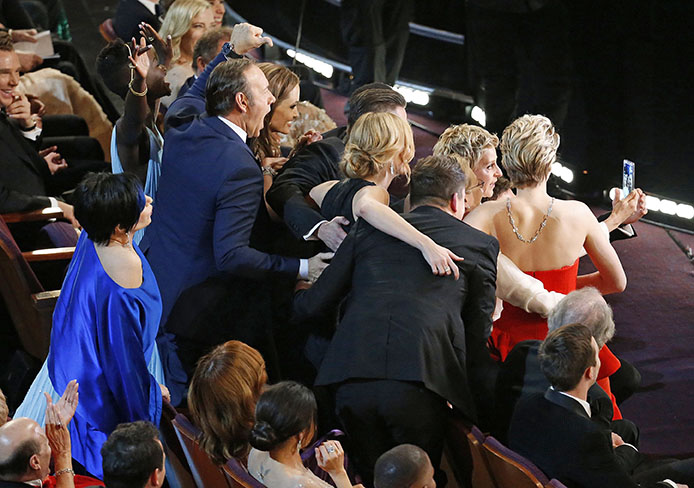 Ellen DeGeneres takes a selfie with attendees during the 86th annual Academy Awards on Sunday, March 2, 2014, at the Dolby Theatre at Hollywood & Highland Center in Los Angeles. Credit: Courtesy of MCT