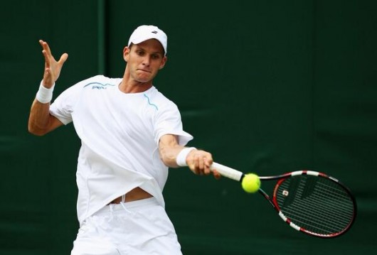 Former Ohio State tennis player Blaz Rola hits the ball in a match against Spain's Pablo Andujar June 23 at Wimbledon in Wimbledon, England. Rola won, 6-3, 6-1, 6-4. Credit: Courtesy of OSU Athletics