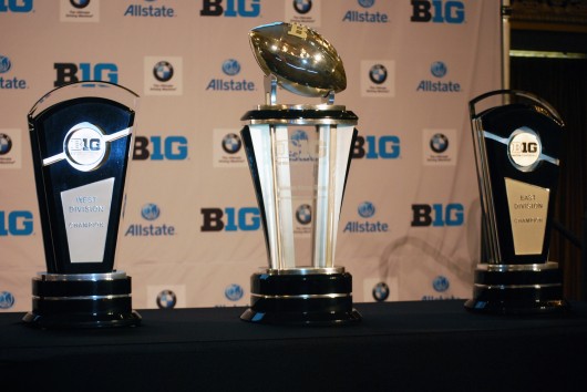 The trophies for the Big Ten West Division (left), Big Ten Championship (center) and the Big Ten East Division sit alongside the podium during the 2014 Big Ten Media Days July 28 in Chicago. Credit: Tim Moody / Lantern sports editor