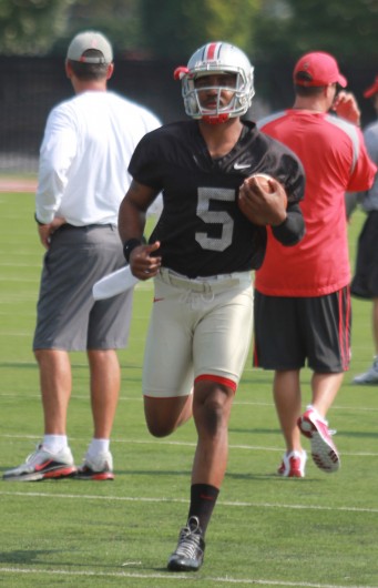 OSU senior quarterback Braxton Miller warms up for the first session of fall practice Aug. 4 at the Woody Hayes Athletic Center in Columbus. Miller missed the entirety of spring practice after undergoing shoulder surgery. Credit: Tim Moody / Lantern sports editor