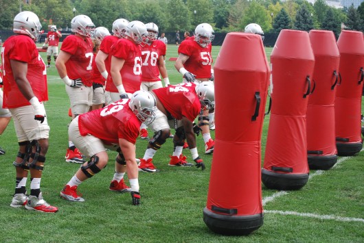 OSU freshmen offensive linemen Brady Taylor (79) and Marcelys Jones (64) get set for a drill as freshman offensive lineman Demetrius Knox (78), senior offensive lineman Joel Hale (51) and other members of the OSU football team look on during fall camp Aug. 6 at the Woody Hayes Athletic Center in Columbus. Credit: Tim Moody / Lantern sports editor