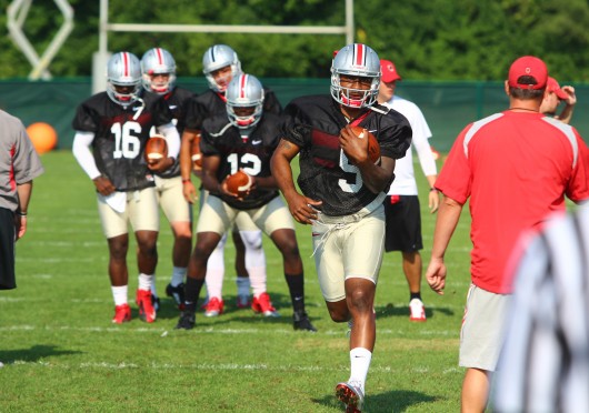 OSU senior quarterback Braxton Miller runs the ball at a practice on Aug. 9 at the Woody Hayes Athletic Center. Miller would later reinjure his right throwing shoulder and OSU announced that he would sit out the 2014 season in its entirety.  Credit: Mark Batke / Photo editor
