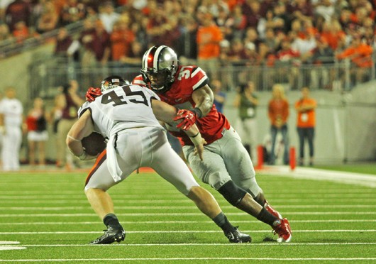 Junior linebacker Joshua Perry (37) attempts to tackle Virginia Tech sophomore fullback Sam Rogers during a game Sept. 6 at Ohio Stadium. OSU lost, 35-21. Credit: Mark Batke / Photo editor