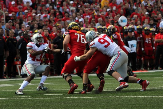 Sophomore defensive lineman Joey Bosa (97) makes a tackle during a game against Maryland on Oct. 4 at Byrd Stadium in College Park, Md. OSU won, 52-24, as Bosa tallied 1 sack and 2.5 tackles for loss. Credit: Mark Batke / Photo editor
