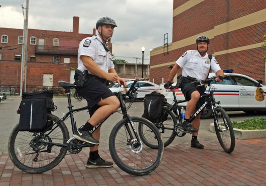 Officers Christopher Billman (left) and Phillip Walls of the Columbus Police bike patrol mount their bikes Sept. 10. Credit: Chelsea Spears / Multimedia editor