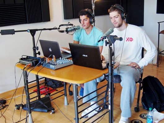 CLLC Radio DJs Sid Fragoulis (left), a second-year in exploration, and Nick Galouzis, a fourth-year in modern greek, conduct their first live broadcast of the semester to listeners. Credit: Courtesy of CLLC Radio
