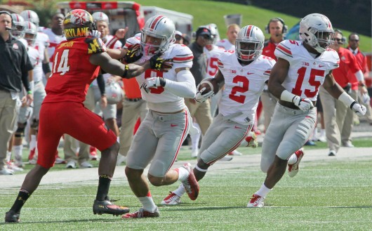Sophomore H-back Dontre Wilson (2) carries the ball as senior wide receiver Devin Smith (9) and sophomore running back Ezekiel Elliott (15) block during a game against Maryland on Oct. 4 at Byrd Stadium in College Park, Md. OSU won, 52-24. Credit: Mark Batke / Photo editor