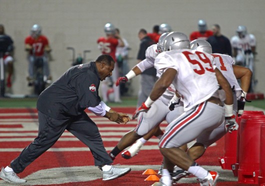 OSU defensive line coach Larry Johnson (left) works with members of the defensive line during spring practice March 20 at the Woody Hayes Athletic Center. Credit: Mark Batke / Photo editor