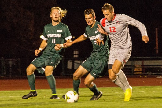 Sophomore defender Tyler Kidwell (12) fights for the ball during a game against Michigan State on Oct. 4 at Jesse Owens Memorial Stadium. OSU won, 3-2. Credit: Ed Momot / For The Lantern