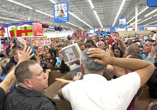 Shoppers who didn’t wait until midnight jostle and grab for cotton sheets as employees unpack the sale items after converging at a Walmart store shortly before 8 p.m. on Nov. 22, 2012, to get a head start on Christmas shopping. Credit: Courtesy of TNS
