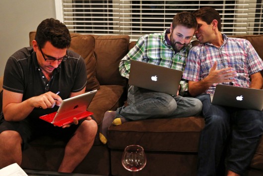 From left, Frank Baiocchi, Murphy Monroe and Jonathan Hoenig gather during their fantasy football draft picks at the home of one of their friends, in Deerfield, Ill., on Sept. 1, 2013. Credit: Courtesy of TNS