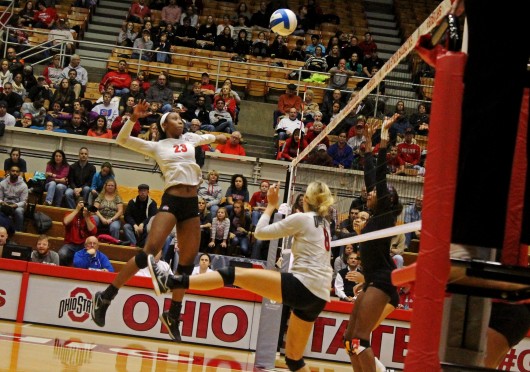 OSU junior middle blocker Tyler Richardson (23) leaps to spike a set by OSU senior setter Taylor Sherwin (8) during a match against Maryland on Nov. 7 at St. John Arena.  Credit: Madelyn Grant / Lantern photographer
