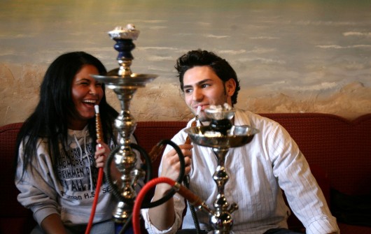 Olivia Polychroni, 18, left, and friend Ahmad Seblini, 18, smoke hookah at Sinbad Grand Cafe in Dearborn, Michigan, April 25, 2007. Credit: Courtesy of TNS