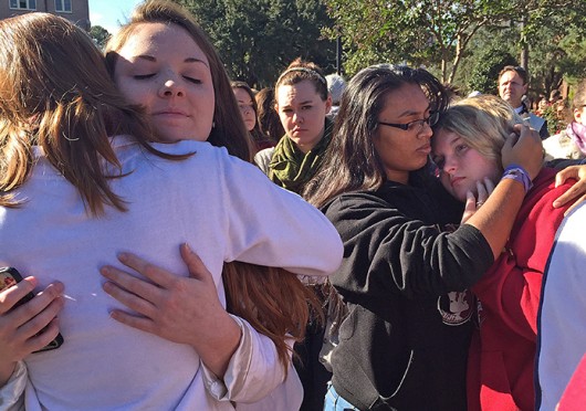 Students comfort each other the morning of Nov. 20 after the previous night's shooting at Florida State University's Strozier Libarary in Tallahassee, Fla. Credit: TNS