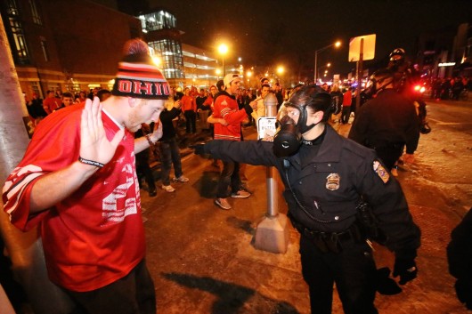 A Columbus Police officer attempts to control a fan on North High Street in the early morning of Jan. 13. Credit: Yann Schreiber / Lantern reporter