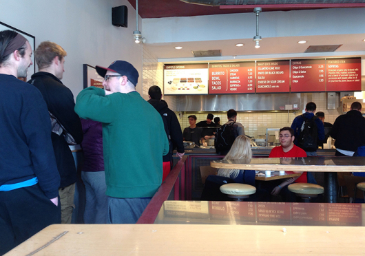 People stand in line at Chipotle, located at 1726 N. High St. Credit: Alaina Bartel / Lantern reporter