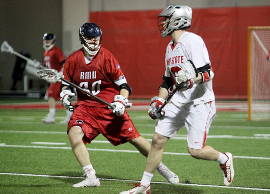 Senior midfielder Jesse King (right) carries the ball during a game against Robert Morris on Feb. 10 at the Woody Hayes Athletic Center. OSU won, 10-6. Credit: Molly Tavoletti / Lantern reporter