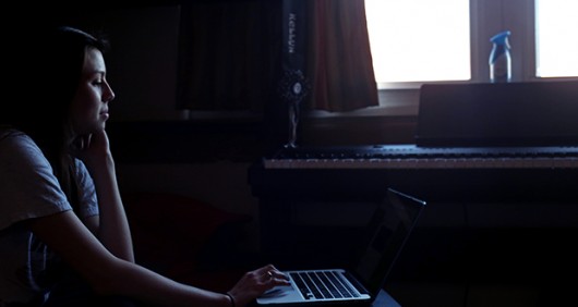 Kellyn McNally, a first-year in microbiology, reads from her laptop inside Morrison Tower on March 25. Credit: Jon McAllister / Photo Editor