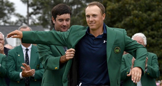 Bubba Watson (left) helps Jordan Spieth into his green jacket after Spieth won the Masters on April 12 at Augusta National Golf Club in Augusta, Ga.