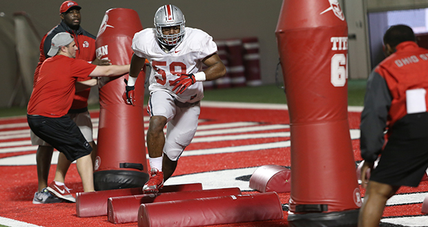 Redshirt-sophomore defensive lineman Tyquan Lewis (59) performs a drill during a March 26 practice at the Woody Hayes Athletic Center. Credit: Mark Batke / Photo editor
