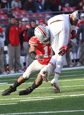 Then-sophomore safety Vonn Bell (11) makes a tackle during a game against Indiana on Nov. 22 at Ohio Stadium. OSU won, 42-27. Credit: Mark Batke / Photo editor