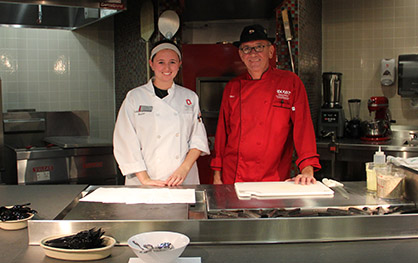 Chef Marc Dullin (right) and his teaching assistant Victoria Figliomeni, a fourth-year in hospitality management. Credit: Samantha Hollingshead / Photo Editor