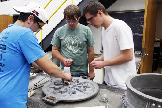 Engineer students work to clean and prepare the Foundry Members mold during their meeting on Tuesday, Oct. 7 in Watts Hall. Credit: Ian Bailey / Lantern Reporter